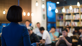 woman speaking to a group of people